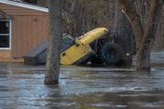 A Jeep wedged up against a tree to prevent the motor from being flooded along the Pompton River near Fairfield Road in Wayne on Tuesday, December 19, 2023.