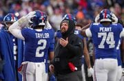 New York Giants head coach Brian Daboll (center) has words with quarterback Tyrod Taylor (2) after Taylor could not get the ball to a wide-open Saquon Barkley for a two point conversion late in the fourth quarter against the Los Angeles Rams, Sunday, Dec. 31, 2023 in East Rutherford, N.J. The Rams won, 26-25.