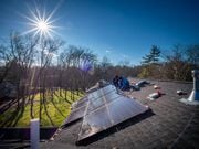 Phil Romeo, left, and Gary Carmona, right, with NJ Solar Power work on the roof of a home in Millburn on Wednesday, December 13, 2023. It's one of more than 188,000 solar installations across New Jersey.