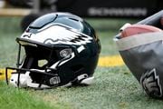 Philadelphia Eagles helmet sits on the sideline during an NFL football game between the Philadelphia Eagles and the Washington Football Team, Sunday, Jan. 2, 2022, in Landover, Md. (AP Photo/Mark Tenally)
