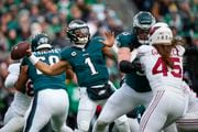 Philadelphia Eagles quarterback Jalen Hurts (1) throws a pass against the Arizona Cardinals during the second half of an NFL football game, Sunday, Dec. 31, 2023, in Philadelphia.