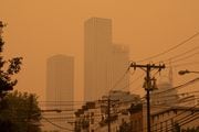 An orange smoky haze from the Canadian wildfires hangs over Journal Square in Jersey City on June 7, 2023. (Reena Rose Sibayan | The Jersey Journal)