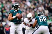 Philadelphia Eagles quarterback Jalen Hurts, left, looks to pass against the Arizona Cardinals during the first half of an NFL football game, Sunday, Dec. 31, 2023, in Philadelphia.