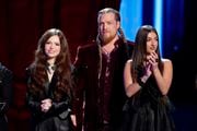 From left: Mara Justine, Huntley and Nini Iris wait to learn their fate on "The Voice."
