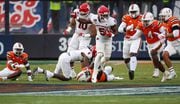 Rutgers Scarlet Knights running back Kyle Monangai (5) breaks into the Miami Hurricanes secondary on the first play from scrimmage, during the first quarter of the Pinstripe Bowl, Thursday, Dec. 28, 2023 at Yankee Stadium.